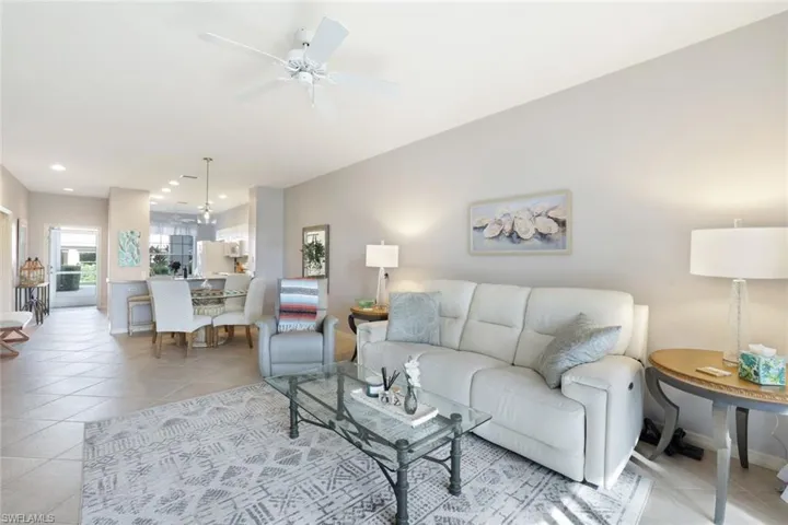 Living room featuring ceiling fan and light tile patterned floors
