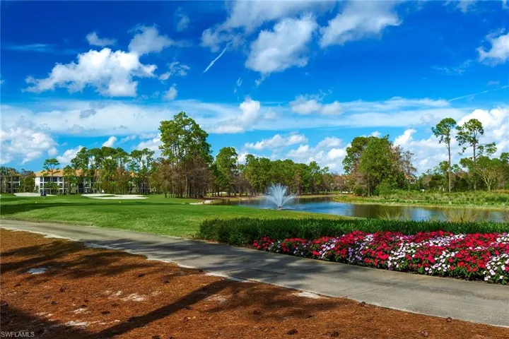 Surrounding community featuring a water view and a lawn