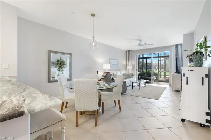 Dining space featuring light tile patterned floors and ceiling fan