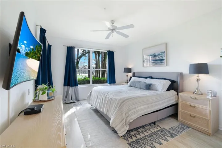 Bedroom with ceiling fan and light hardwood / wood-style flooring