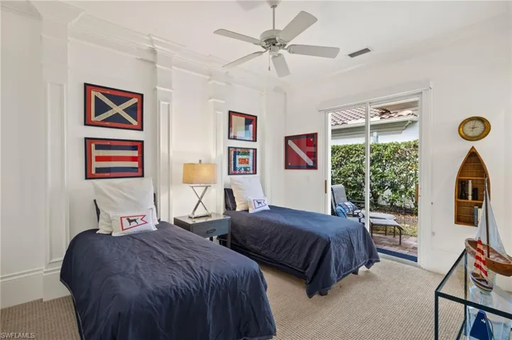 Carpeted bedroom with crown molding, ceiling fan, and access to outside