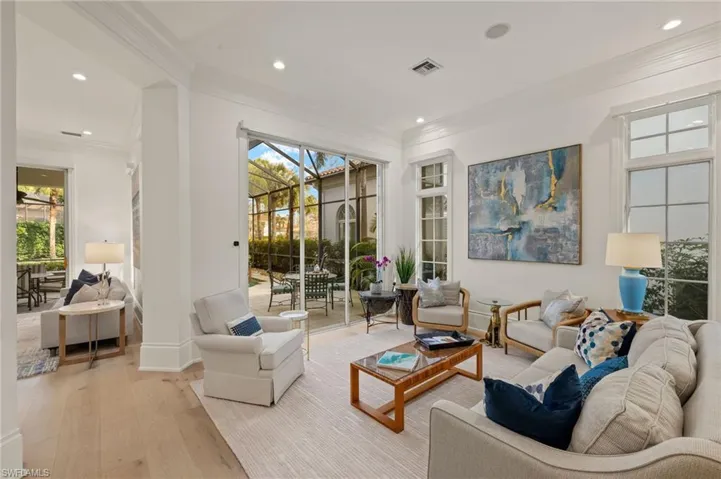 Living room featuring ornamental molding and light wood-type flooring