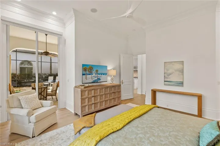 Bedroom featuring crown molding, light hardwood / wood-style floors, and ceiling fan