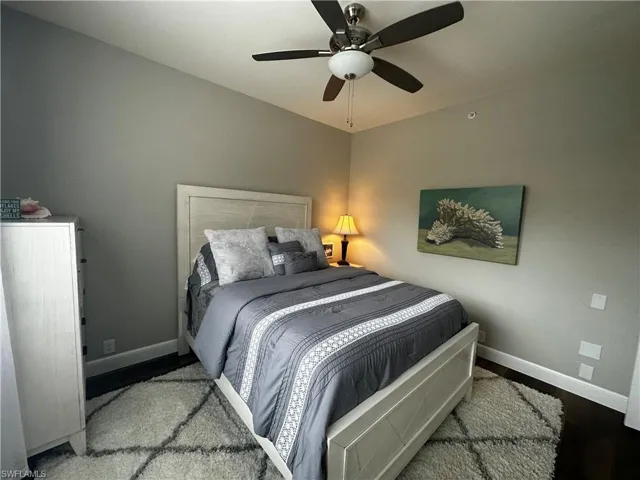 Bedroom featuring baseboards, ceiling fan, and wood finished floors