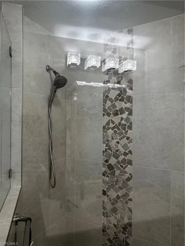 Full bath with tiled shower
