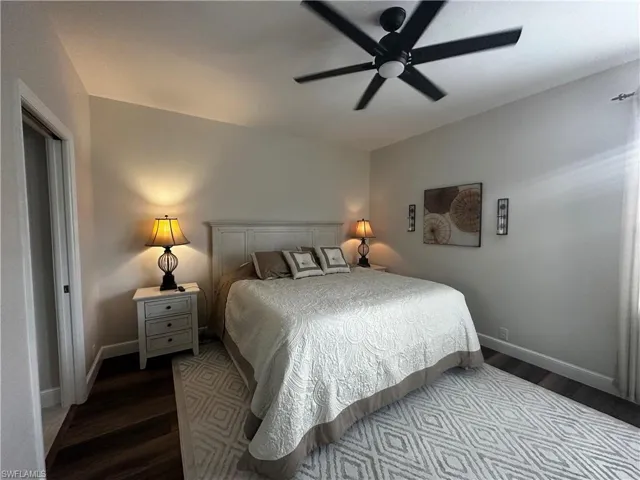 Bedroom featuring baseboards, a ceiling fan, and wood finished floors