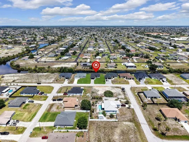 Aerial perspective featuring a residential neighborhood with numerous single-story homes