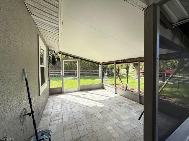 Unfurnished sunroom with vaulted ceiling and healthy amount of natural light