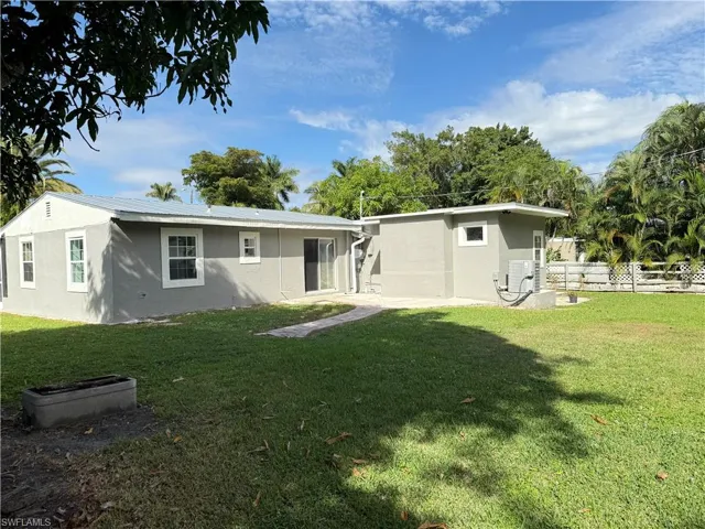 Rear view of house with stucco siding and a patio area
