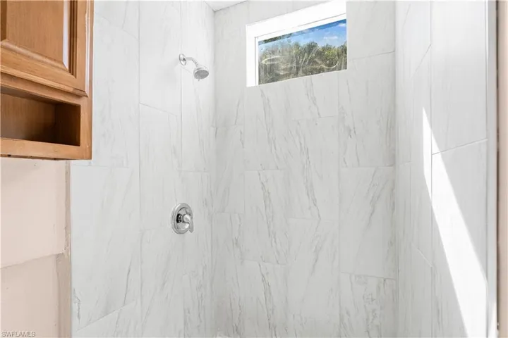 Bathroom featuring tiled shower