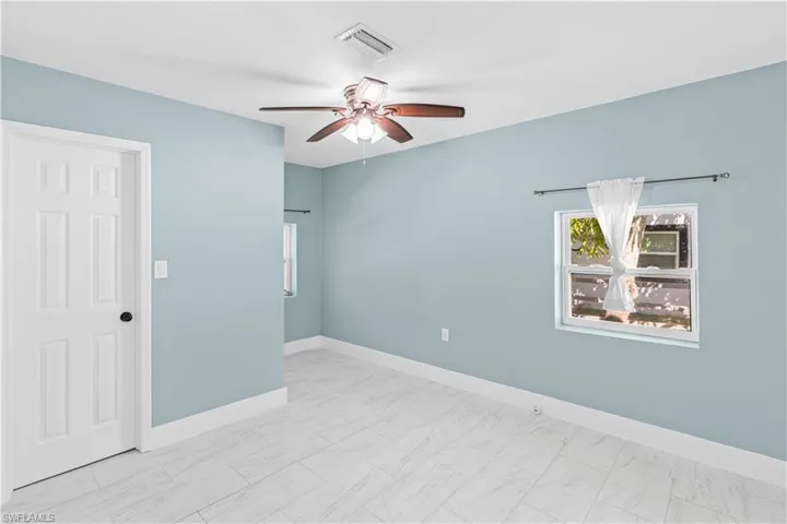 Spare room featuring baseboards and a ceiling fan