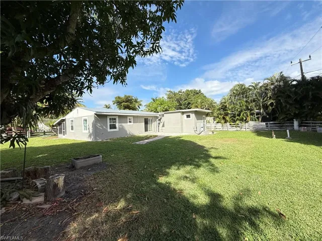 Rear view of property with stucco siding