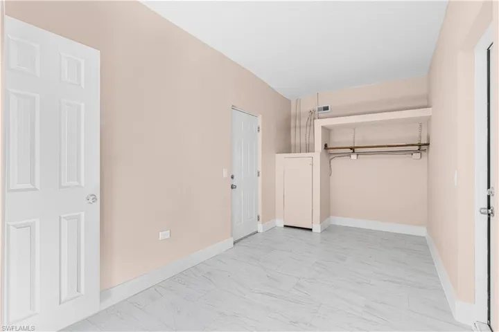 Unfurnished bedroom featuring a closet and baseboards