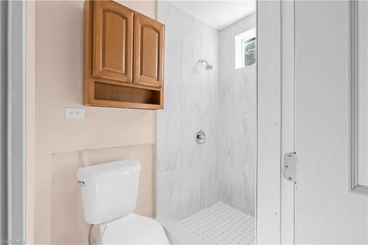 Full bathroom with a shower stall and toilet
