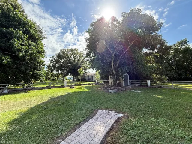 Fenced backyard featuring a storage shed