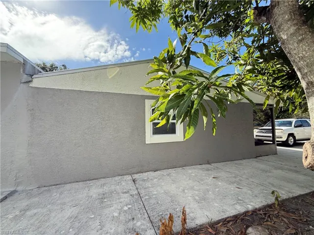 View of side of home featuring stucco siding