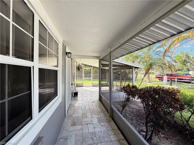 View of patio with a sunroom