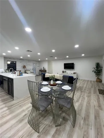 Dining area with light wood-style floors and baseboards