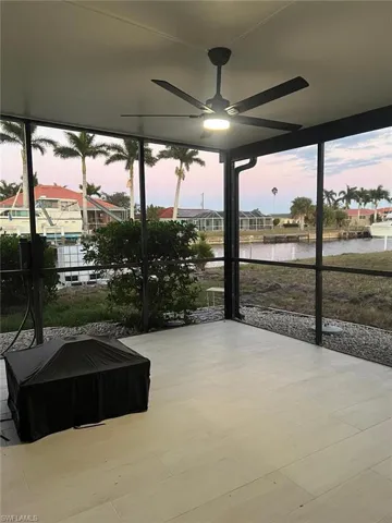 Sunroom / solarium with a water view and healthy amount of natural light