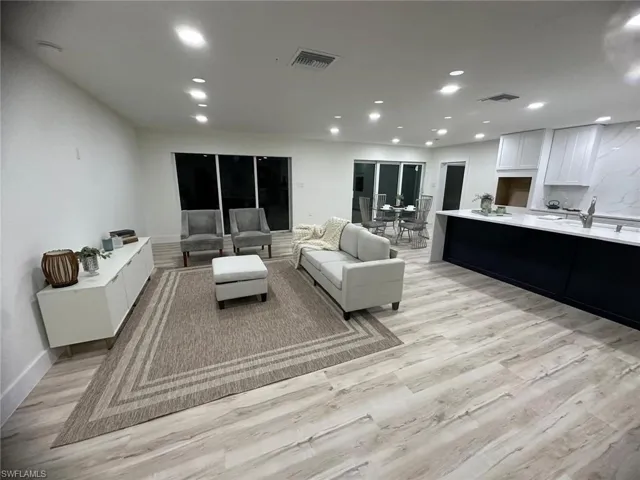 Living area with recessed lighting and light wood-style floors