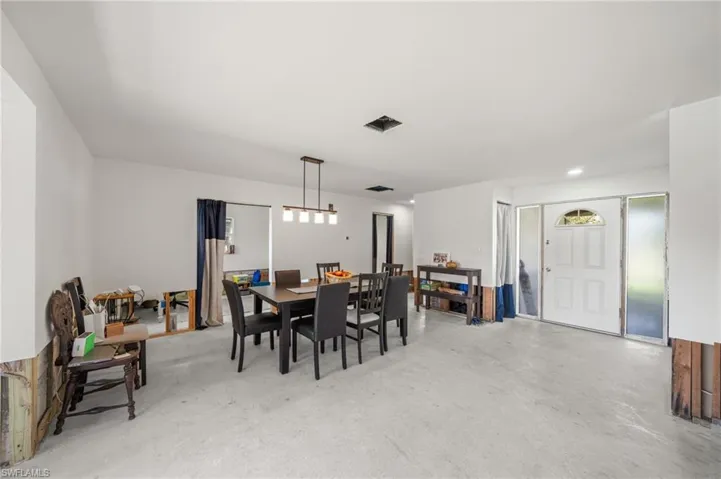 Dining space featuring finished concrete floors