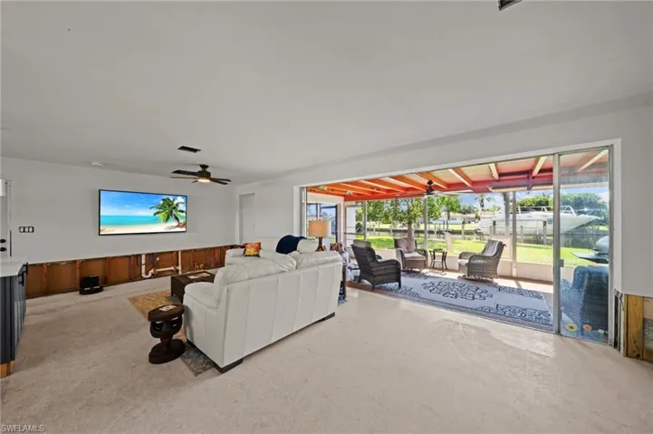 Living room featuring a sunroom and ceiling fan