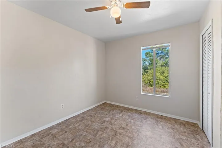 Unfurnished bedroom with a closet and ceiling fan
