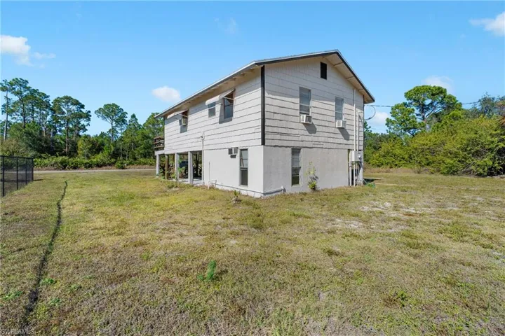 Rear view of property featuring a lawn