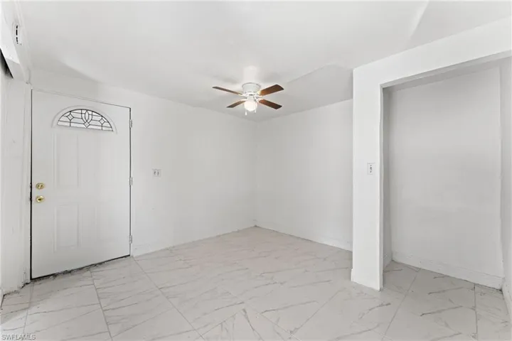 Foyer entrance featuring ceiling fan