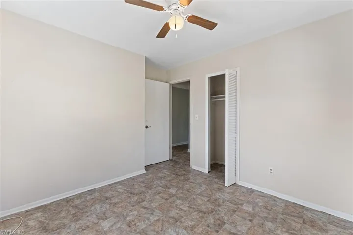 Unfurnished bedroom featuring ceiling fan and a closet