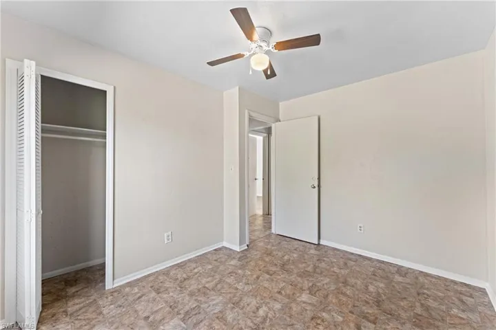 Unfurnished bedroom featuring ceiling fan and a closet