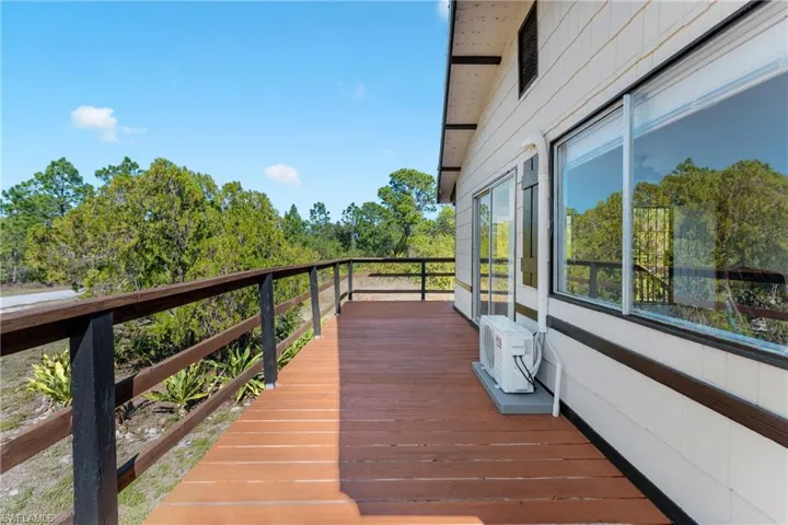 Wooden terrace featuring ac unit