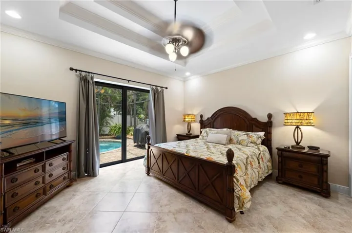 Tiled flooring throughout featuring a tray ceiling with recessed lighting and a ceiling fan