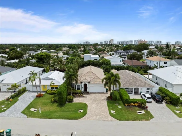 Aerial perspective showcasing a residential street with three distinct properties