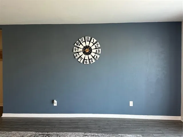 Unfurnished room with dark hardwood / wood-style flooring