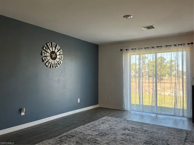Unfurnished room featuring dark hardwood / wood-style floors