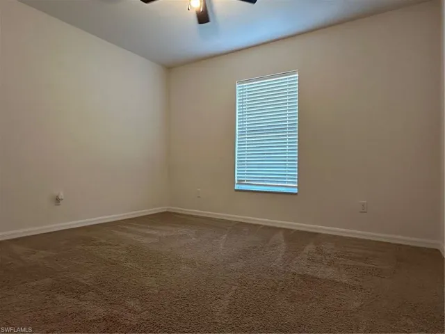 Empty room with carpet flooring and ceiling fan