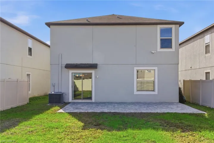 Rear view of house featuring a patio and stucco siding
