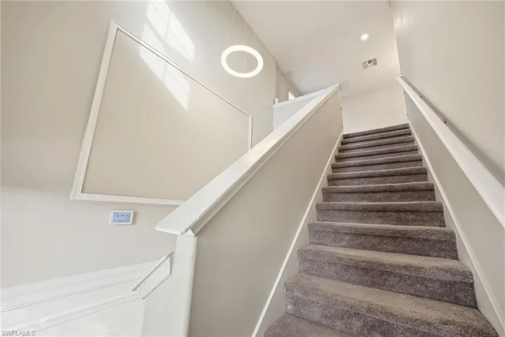 Stairway featuring recessed lighting