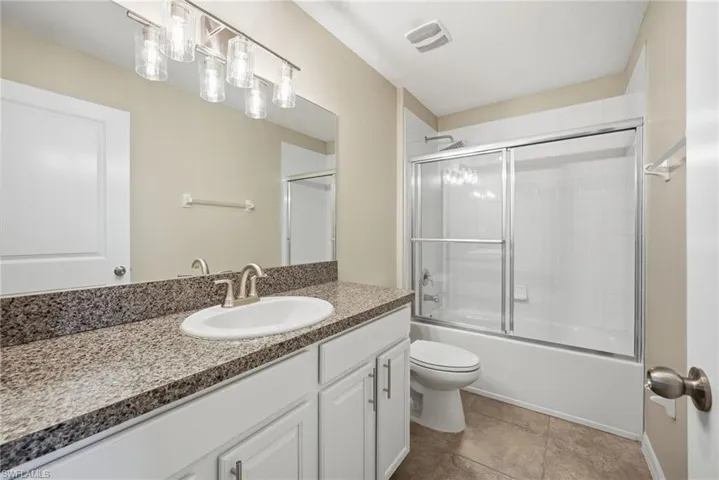 Full bathroom featuring vanity and combined bath / shower with glass door