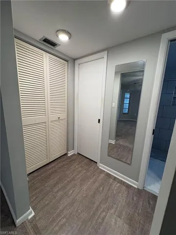 Unfurnished bedroom with dark hardwood / wood-style flooring