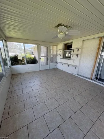 Unfurnished sunroom with ceiling fan