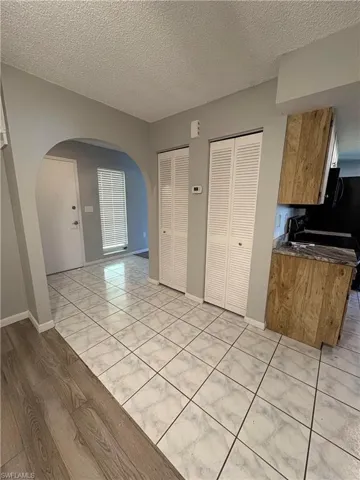 Kitchen with light tile patterned floors and a textured ceiling