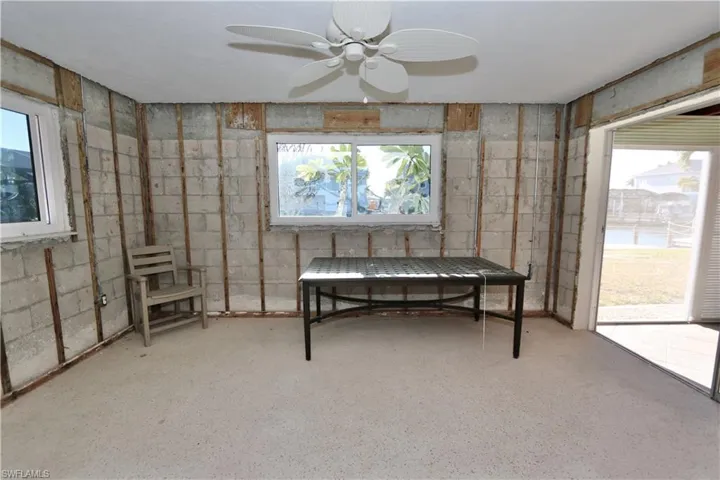 Sitting room featuring healthy amount of natural light and ceiling fan