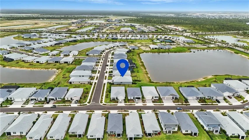 View of property location featuring a large body of water and nearby suburban area