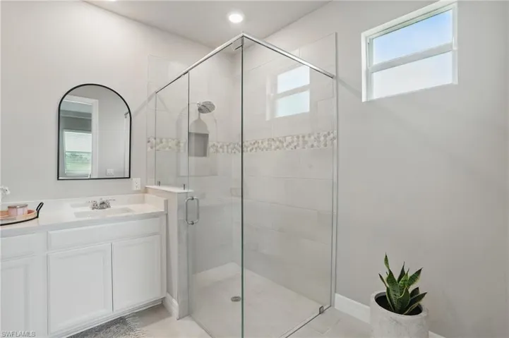 Full bathroom featuring a stall shower and vanity