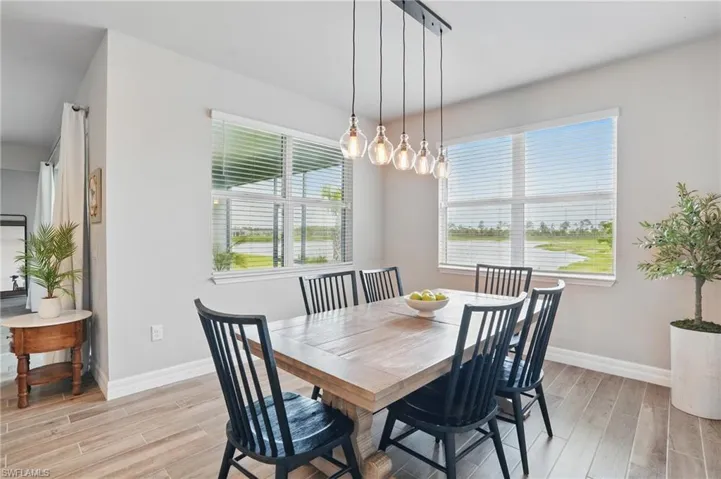 Dining area with light wood-style floors and baseboards