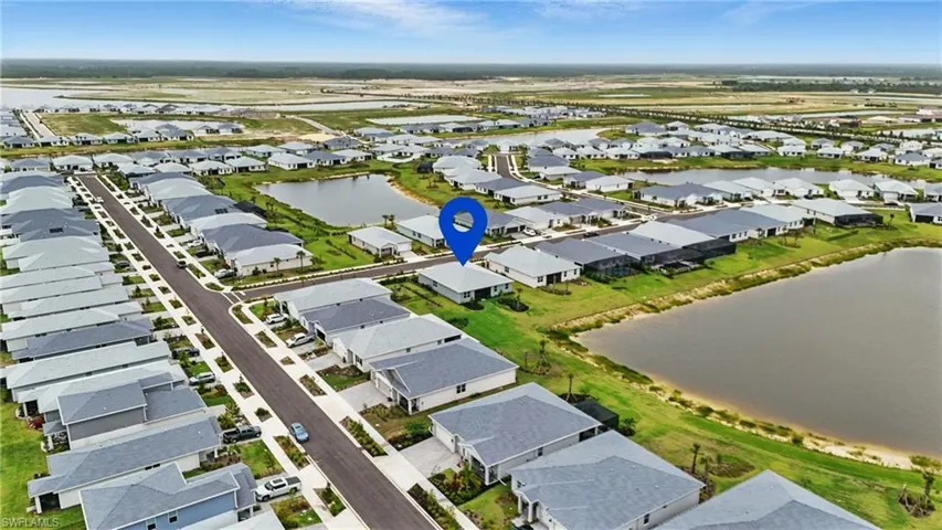 Aerial perspective of suburban area featuring a large body of water