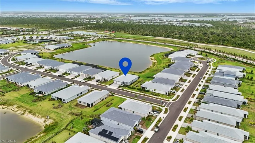 Aerial perspective of suburban area with a nearby body of water