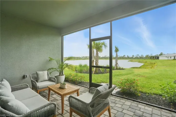 Sunroom featuring a water view and outdoor lounge area